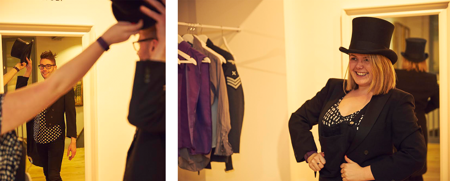 Museum visitors try on vintage clothing and top hats as part of an interactive exhibit at the Jewish Museum London.