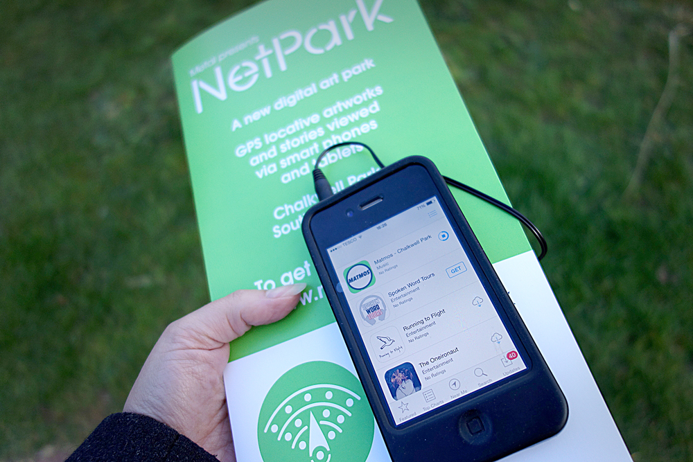 netpark app open on a phone laid over a netpark leaflet that provides information about the app