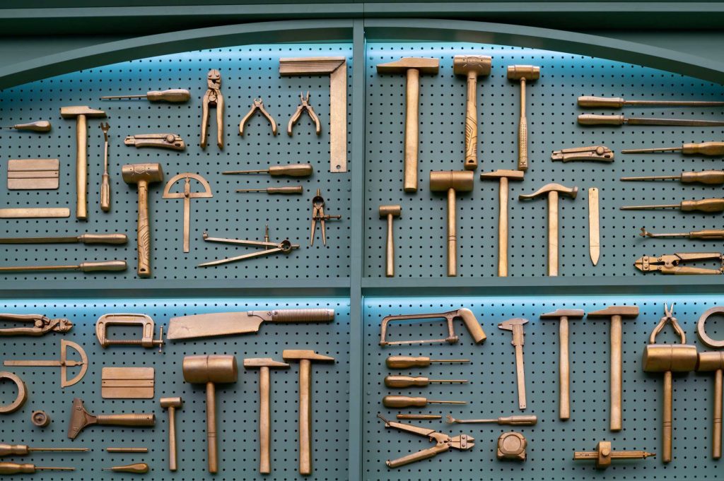 Collection of brass woodworking tools displayed neatly.
