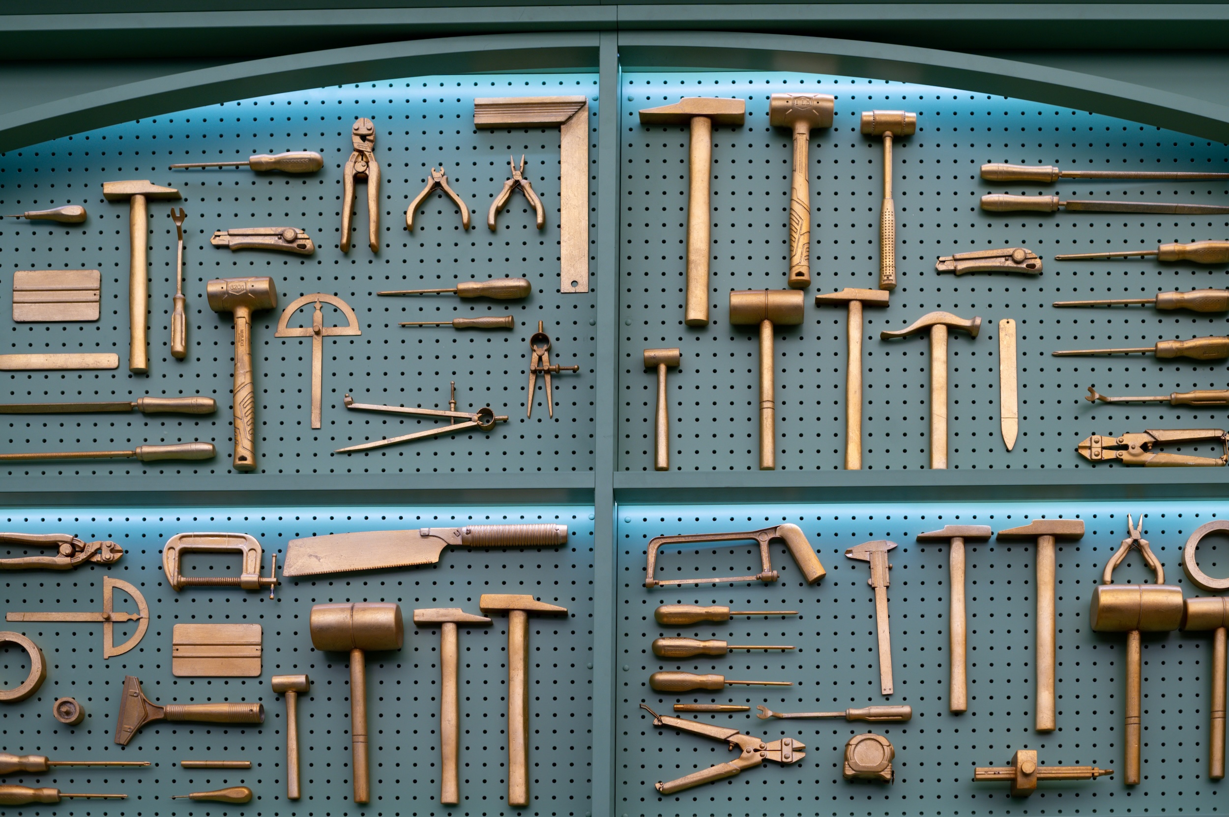 Collection of brass woodworking tools displayed neatly.
