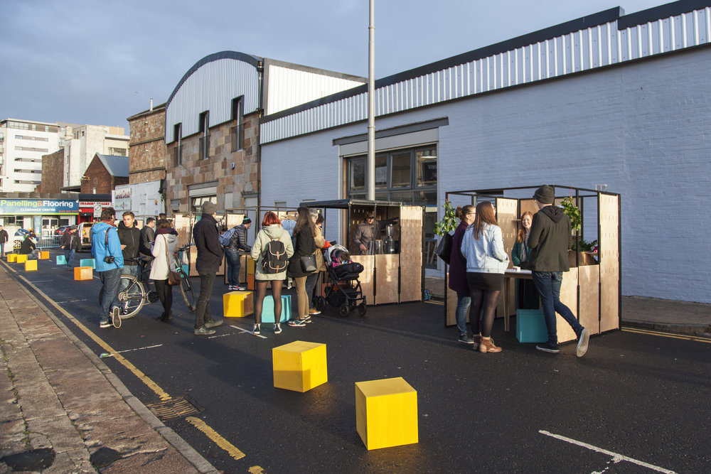 A renovated industrial building and lively external street market