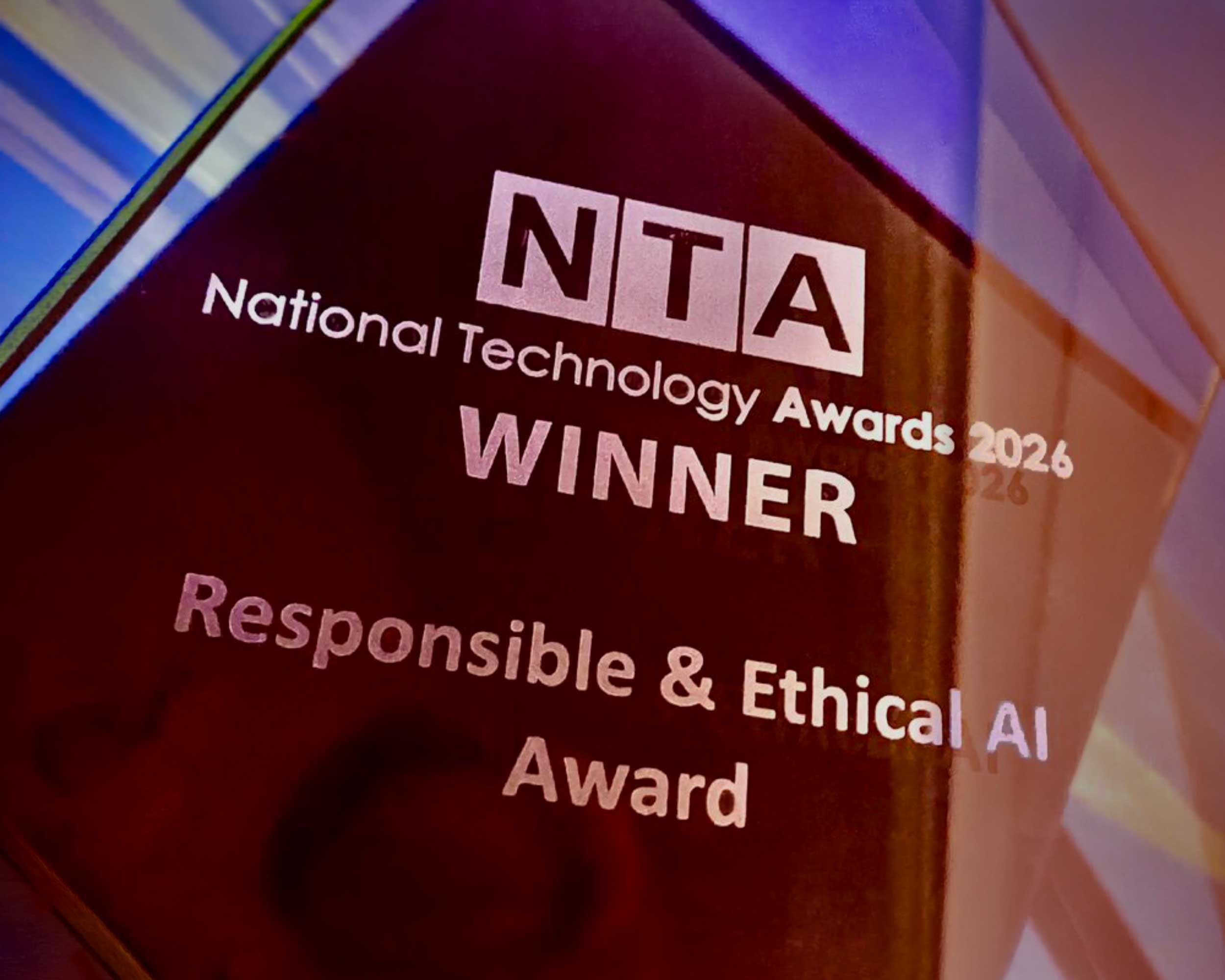 Photo of award statue with blue and red lines of light behind
