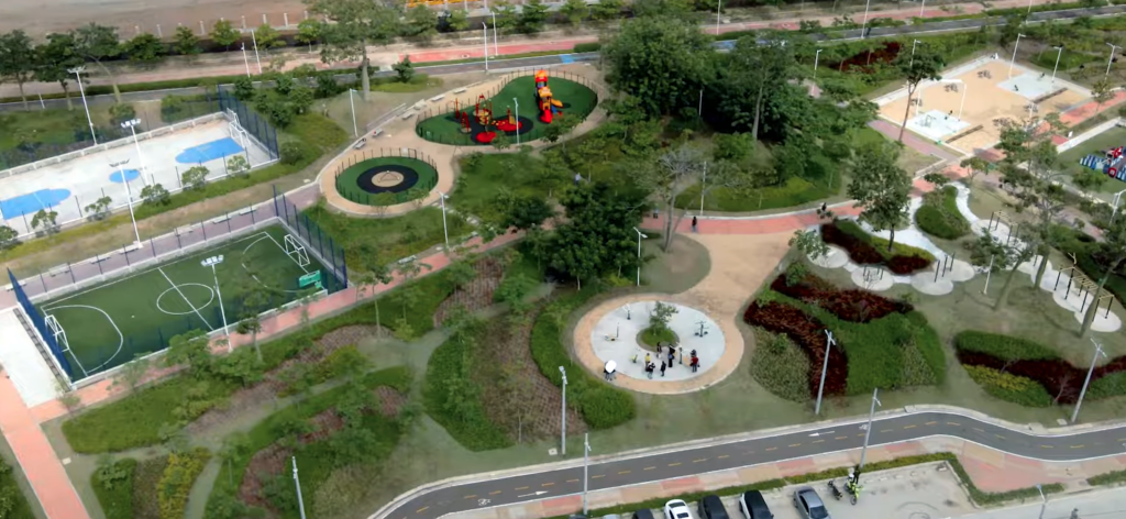 Aerial view of park with sports areas, playpark, paths, seating, planting and lighting