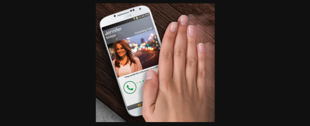A hand moving horizontally above a smartphone screen to answer a phone call.