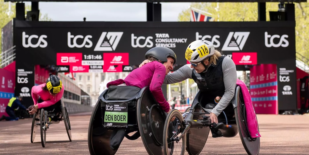 Two handcyclists congratulating each other at race finish line.