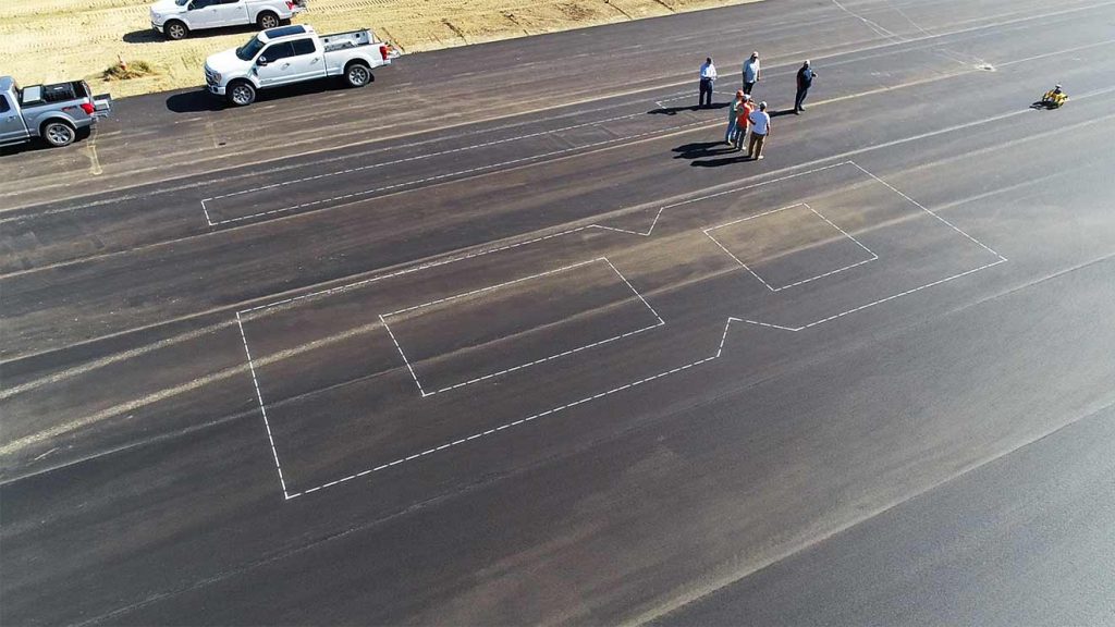 TinySurveyor robot painting numerals on a runway