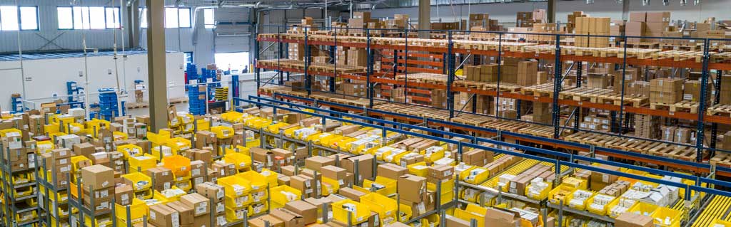 Warehouse full of shelves of stock in card boxes.