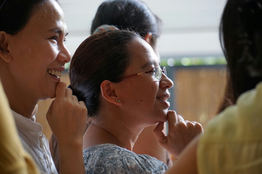 A group of women smiling and in discussion.