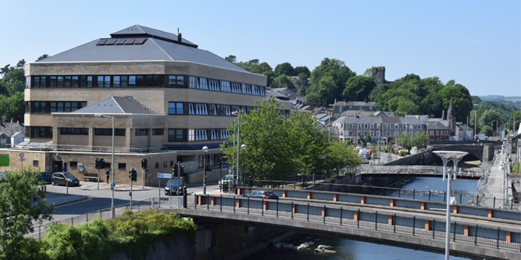 External photo of Bridgend Council offices, with river, trees, houses and roads.
