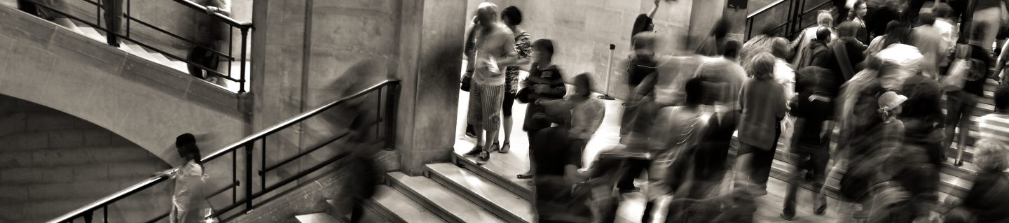 Blurred photo of people on stairs in a public building