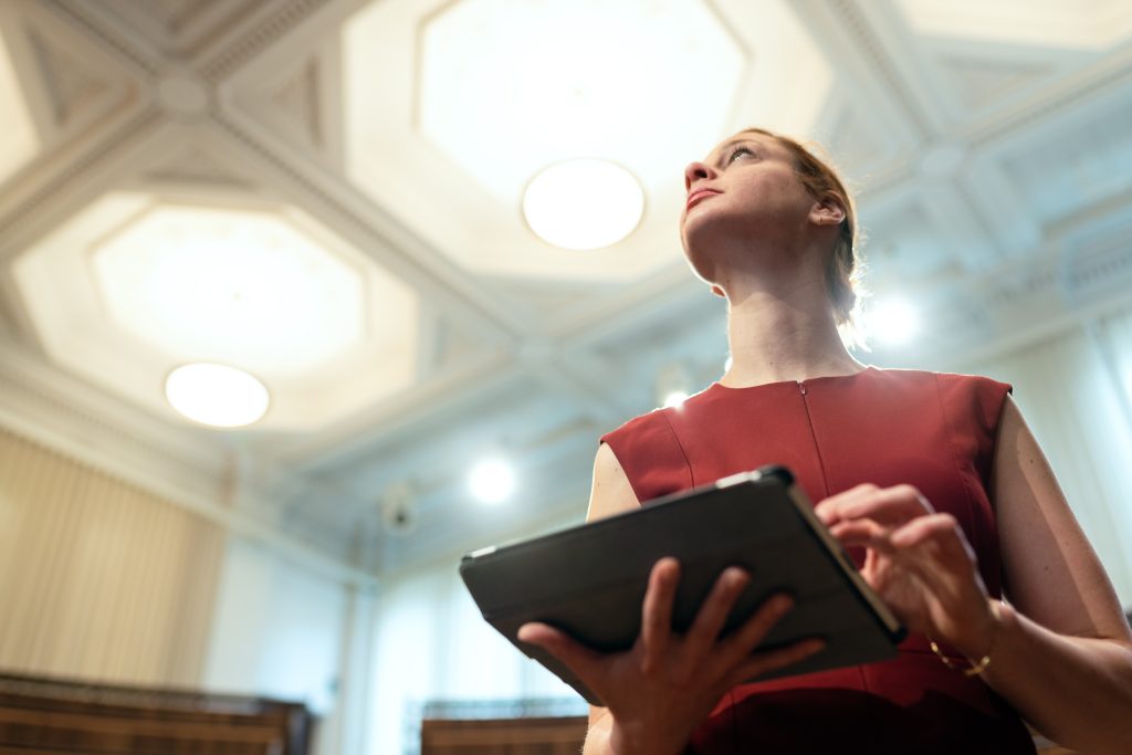 Person with tablet surveying a room